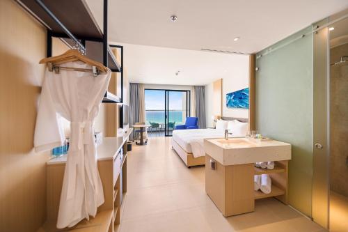 a hotel room with a bed and a bathroom at THE CAM RANH RESORT at Bai Dai in Cam Ranh