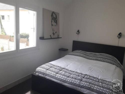 - un lit dans une chambre avec fenêtre dans l'établissement Ar vilin, à Plouézec