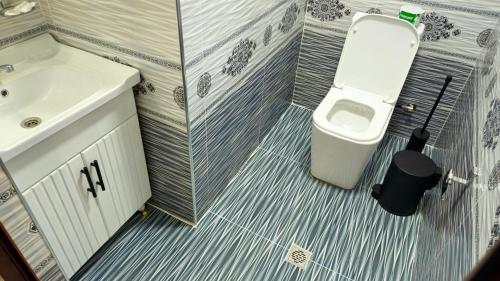 La petite salle de bains est pourvue d'un lavabo et de toilettes. dans l'établissement HOTEL-129, à Samarcande