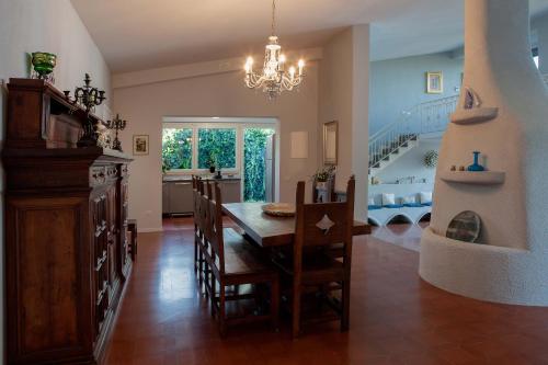 a dining room with a table and chairs and a staircase at Villa Dell'Arco - Sea View, Private Pool & AirCo in SantʼElpidio a Mare