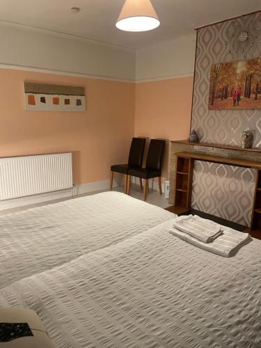 a bedroom with a large bed and a fireplace at Private Room 2 Near Southmead Hospital, Bristol in Bristol