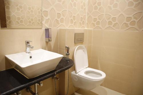 a bathroom with a sink and a toilet at Hotel- The Yellow Queen in Guwahati