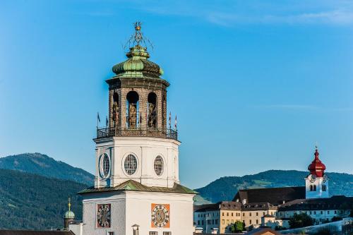 a building with a clock tower on top of it at Boutiquehotel am Dom in Salzburg