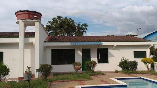 a house with a water tower on top of it at Villa Rosita in Villeta