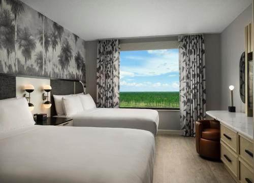 a hotel room with two beds and a window at Caribe Royale Orlando in Orlando