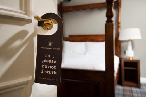 a sign on the door of a hotel room at The King's Head Inn - The Inn Collection Group in Great Ayton