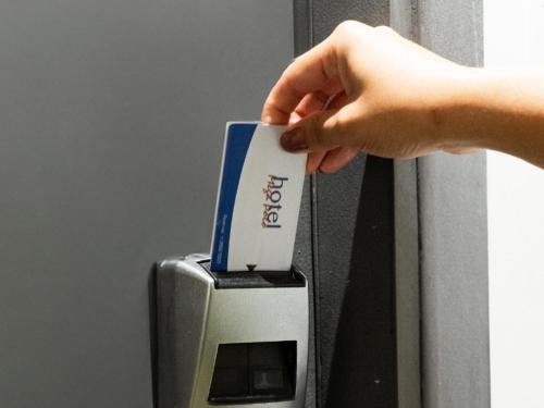 a hand is putting a card into an atm machine at Hotel Mega Polo in Sao Paulo