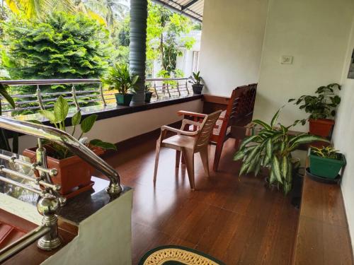 a living room with plants on a balcony at Mary's homestay in Kalpetta