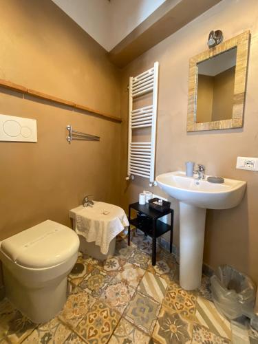 a bathroom with a toilet and a sink at Casale 1541 in Bolsena