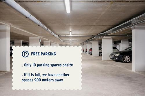 a parking garage with a free parking sign in it at Edgar Suites - Meudon-la-Forêt in Meudon