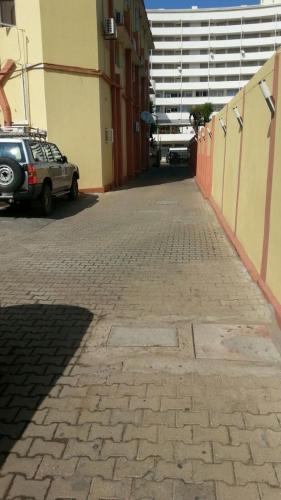a car parked on a brick sidewalk next to a building at Pensao Martins in Maputo