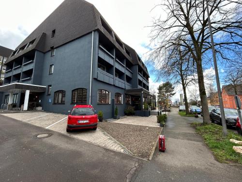 a red car parked in front of a building at Hotel Stadt Homburg in Homburg