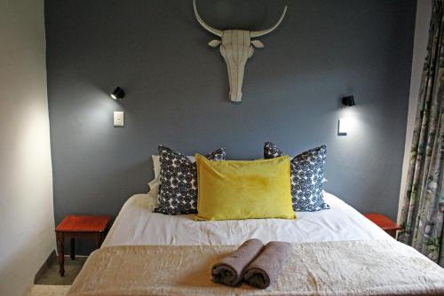 a bedroom with a bed with two slippers on it at Sungubala Eco Camp in Bergville