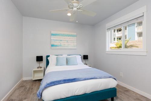 a bedroom with a bed and a ceiling fan at Charming Beach Bungalows - 4BR, Sleeps 10, Pets OK in Carlsbad