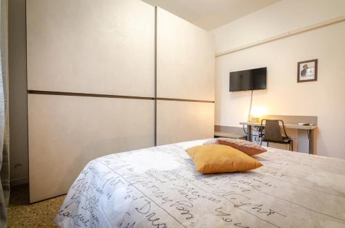 a bedroom with a bed with a yellow pillow on it at B&B Corsini in Bologna