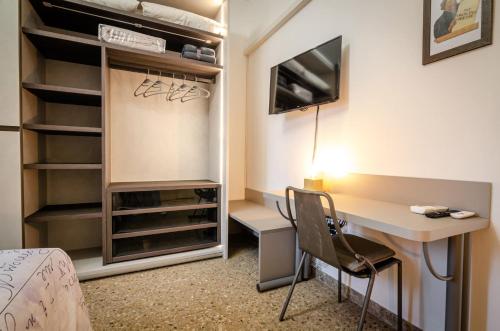 a room with a desk and a bed and a desk and chair at B&B Corsini in Bologna