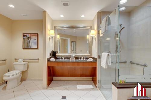a bathroom with a toilet and a sink and a shower at MGM Signature-07-607 Accessible Strip View Balcony in Las Vegas
