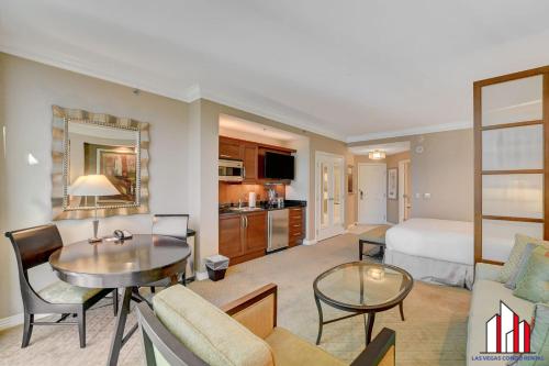 a hotel room with a bed and a living room at MGM Signature-28-719 Strip View Jacuzzi Studio in Las Vegas