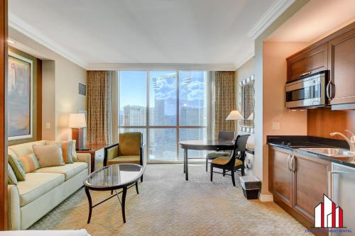 a living room with a couch and a table at MGM Signature-28-719 Strip View Jacuzzi Studio in Las Vegas