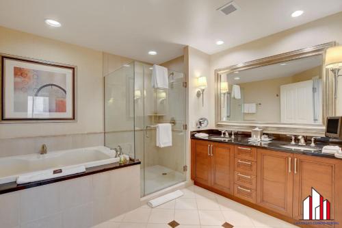 a bathroom with a tub and a shower and a sink at MGM Signature-28-719 Strip View Jacuzzi Studio in Las Vegas