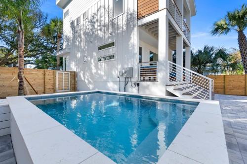 a swimming pool in front of a house at Sunset Cove 2 - Heated Pool - Sea Views - Walkable in St. Augustine