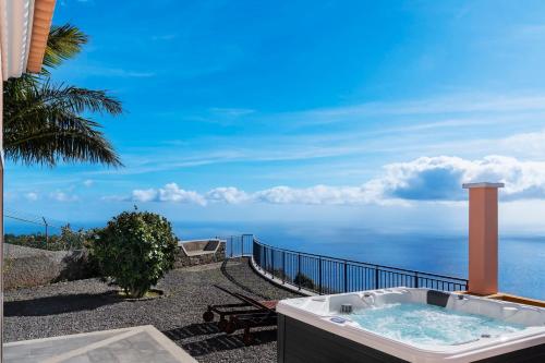 a hot tub with a view of the ocean at With jacuzzi sea view - Casa da Quinta Grande in Câmara de Lobos