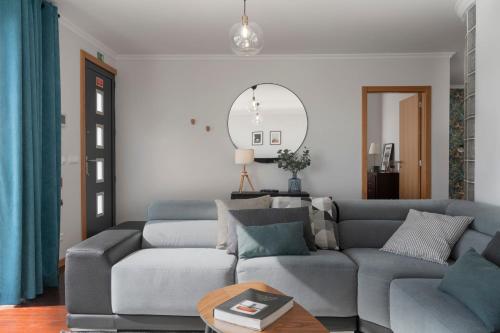 a living room with a couch and a table at Casa da Quinta Grande by An Island Apart in Câmara de Lobos
