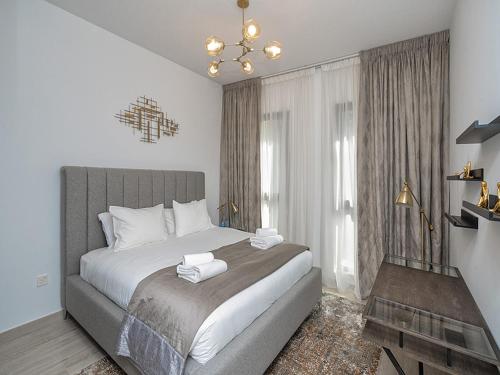 a bedroom with a large bed with two towels on it at Brand new 2 Bedroom apartment in Madinat Jumeirah Living in Dubai