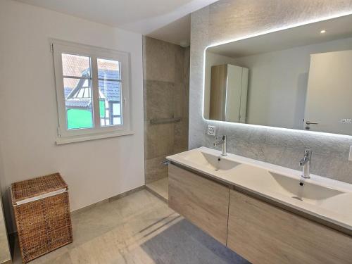 a bathroom with a sink and a mirror at Maison Geispolsheim, 5 pièces, 8 personnes - FR-1-722-5 in Geispolsheim