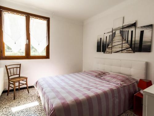 une chambre blanche avec un lit et une chaise dans l'établissement Agréable T2 RDC avec terrasse, proche plage et commerces - FR-1-776-79, à Saint-Cyprien
