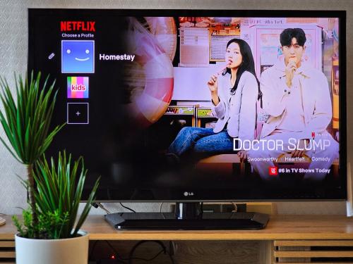 a flat screen tv sitting on top of a table at Loft Suite Seaview near JB CIQ 7pax in Johor Bahru