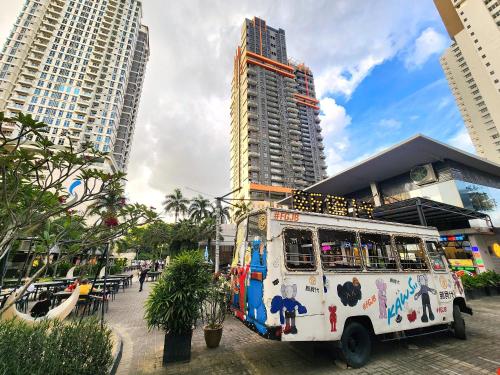 a food truck parked in front of tall buildings at Loft Suite Seaview near JB CIQ 7pax in Johor Bahru