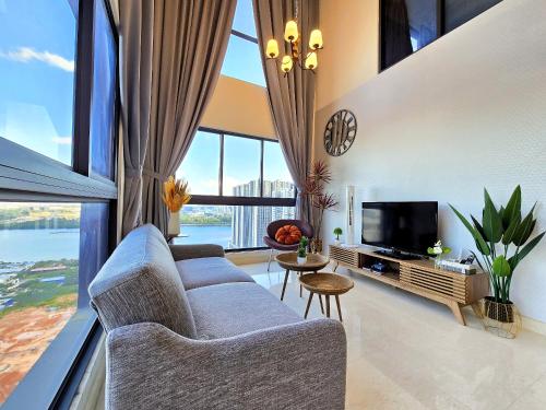 a living room with a couch and a tv at Loft Suite Seaview near JB CIQ 7pax in Johor Bahru