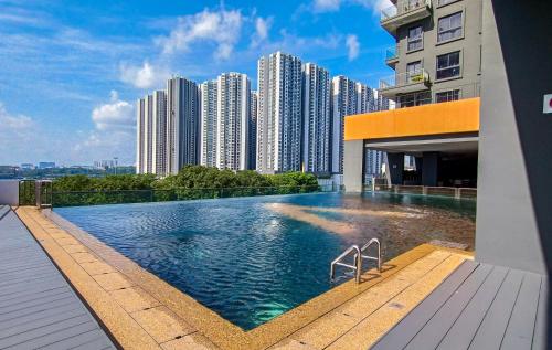 a swimming pool on the roof of a building with tall buildings at Loft Suite Seaview near JB CIQ 7pax in Johor Bahru