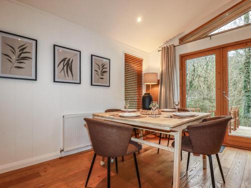 a dining room with a table and chairs at 1 Streamside in Looe