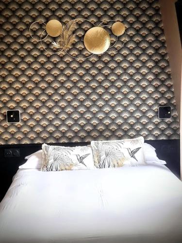 un lit avec des draps blancs et des oreillers dans une chambre dans l'établissement Cosy & chic - Eiffel Tower, à Paris