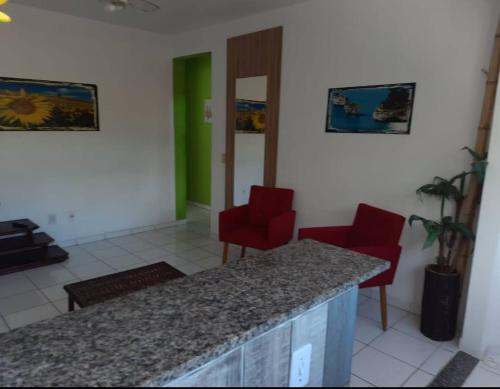 una habitación con 2 sillas rojas y un mostrador en Residence Sonho Azul, en Salvador