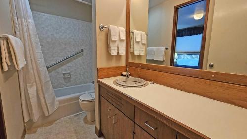 a bathroom with a sink and a toilet and a mirror at Mountain View Lodge 2 in Sunriver