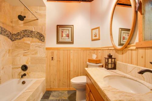 a bathroom with a tub and a toilet and a sink at Cozy Easton Cabin with Wenatchee Natl Forest Views! in Cabin Creek