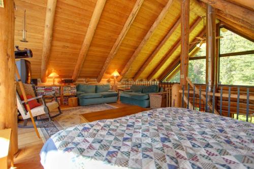 a bedroom with a bed and a living room at Cozy Easton Cabin with Wenatchee Natl Forest Views! in Cabin Creek