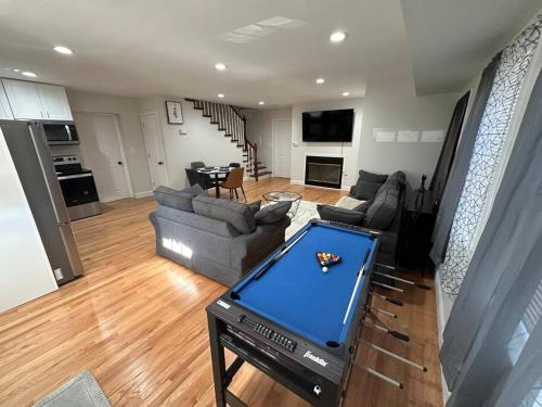 a living room with a pool table in the middle at Modern Luxury Home With Fireplace & Game-Room in Brockton