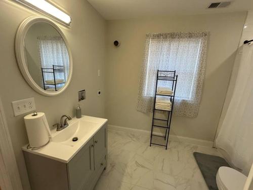 a bathroom with a sink and a mirror at Modern Luxury Home With Fireplace & Game-Room in Brockton