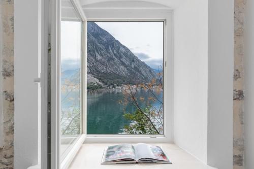 an open window with a view of a mountain at Casa Spada by Belsize in Kotor