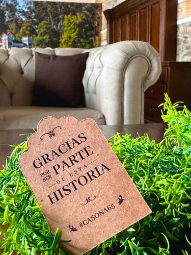 a piece of paper on a table in front of a couch at HOTEL BOUTIQUE CASONA 65 in Puebla