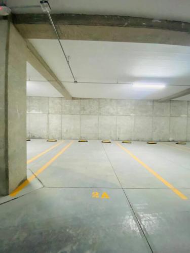 an empty parking garage with yellow lines on the floor at Luxurious and Modern Apartment in North Zone in Aguascalientes