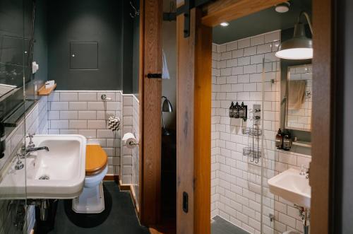 a bathroom with a toilet and a sink at Flint Barns, Rathfinny Wine Estate in Alfriston