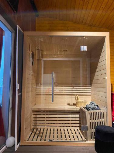 a sauna with a tub in a room at Gold Residence in Ocna-Mureşului