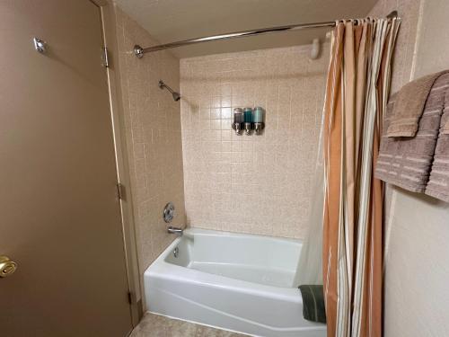 a bathroom with a white tub and a shower at Yosemite Condominium Loft unit -B202 in Yosemite West