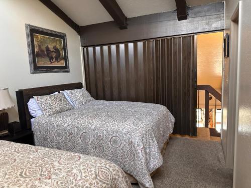 a bedroom with two beds and a sliding glass door at Yosemite Condominium Loft unit -B202 in Yosemite West