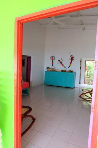 a room with colorful walls and a blue table at Cabaña en primera línea de playa en San Antero con Aire AC y 5 habitaciones in San Antero